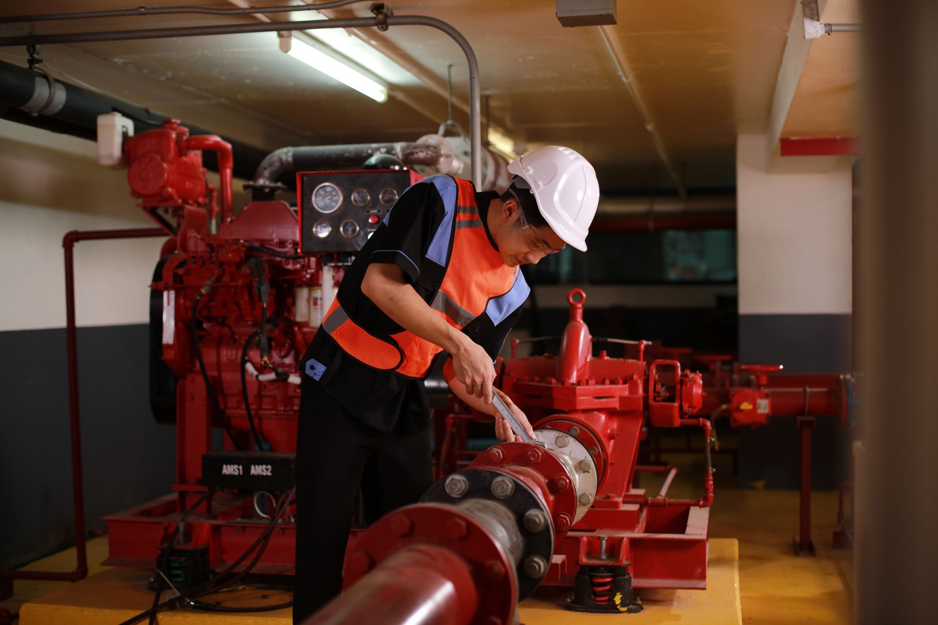 Safety engineers inspect the piping system and operation of fire hydrants in the factory.  Safety Technician inspects fire hydrant system under building construction