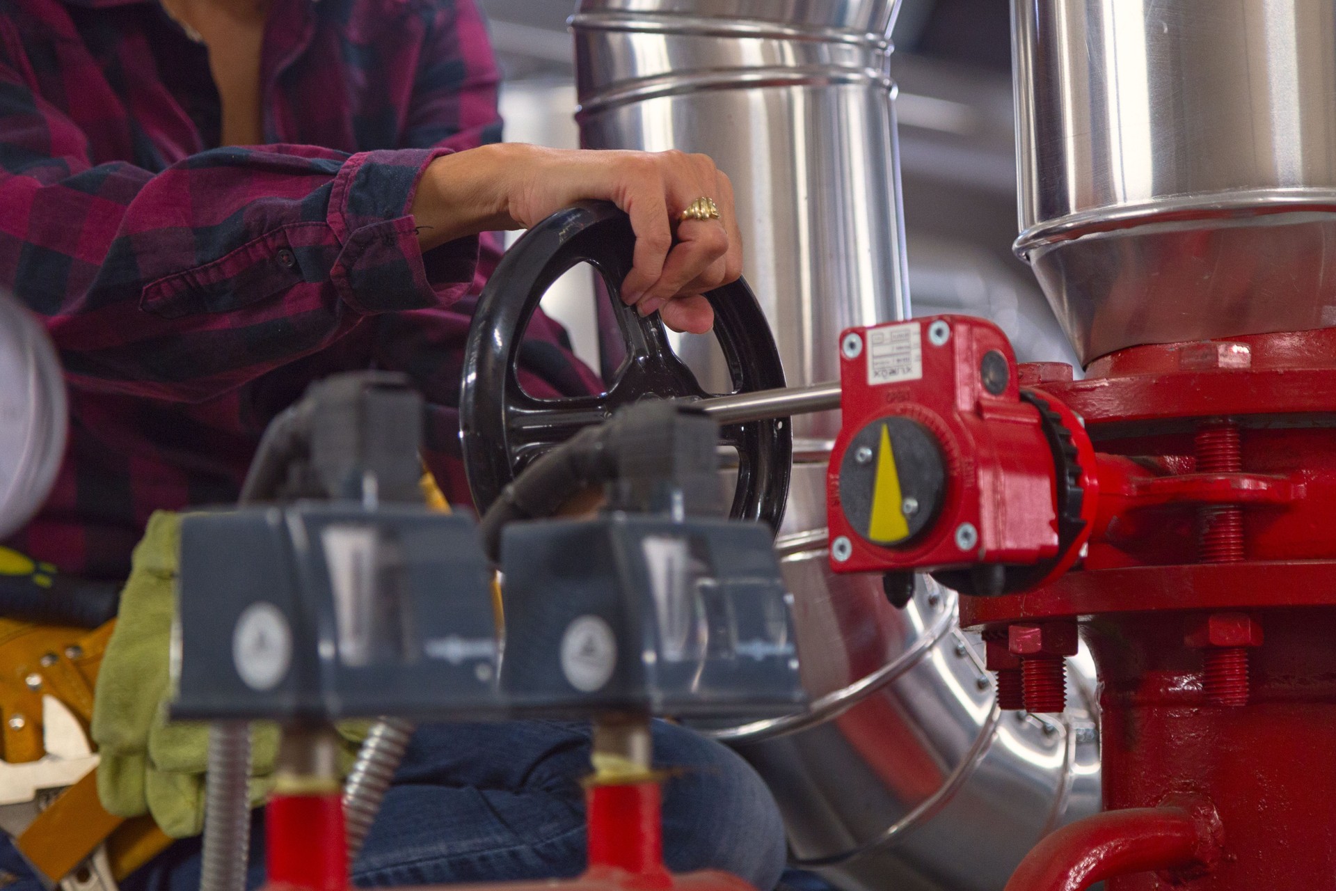 Technician working on valve in factory or utility